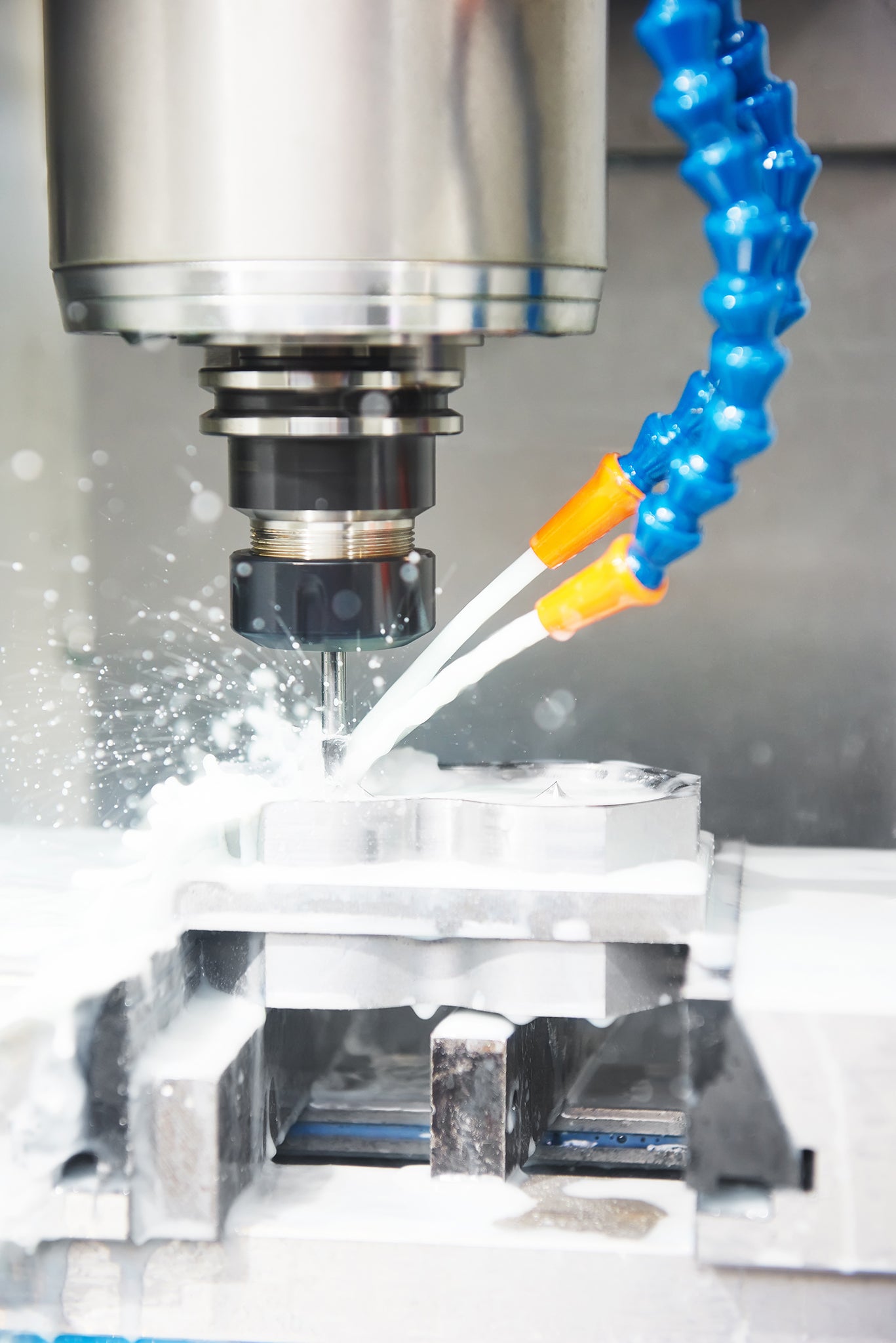 drilling hole or boring detail with lubricant liquid coolant on metal cutting machine tool at factory