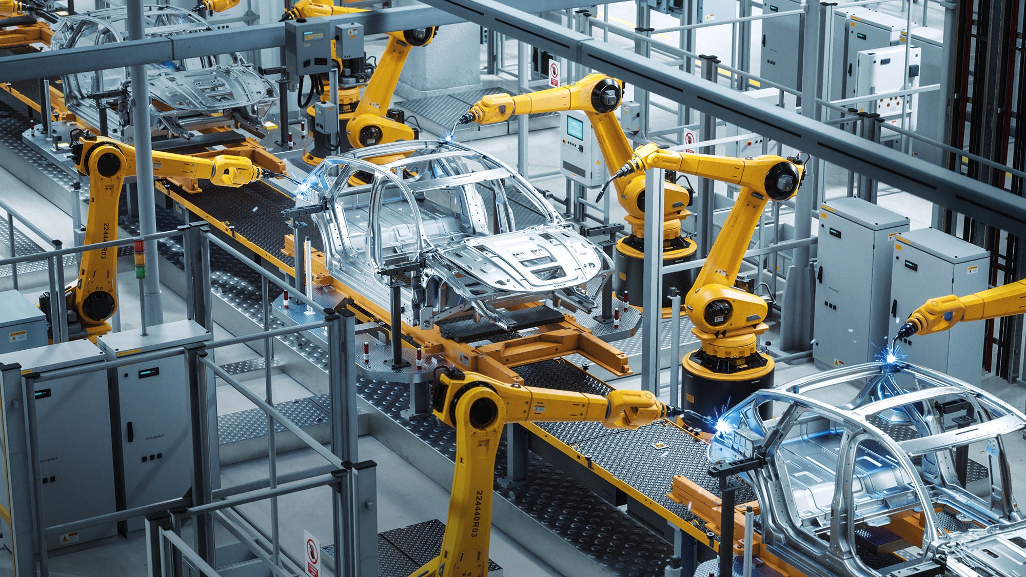 Roboterarme in einer Autofabrik