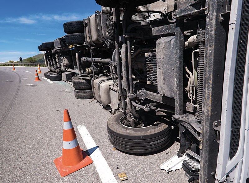 ein LKW, der seitlich umgefallen ist, Die Unfallstelle ist abgesichert